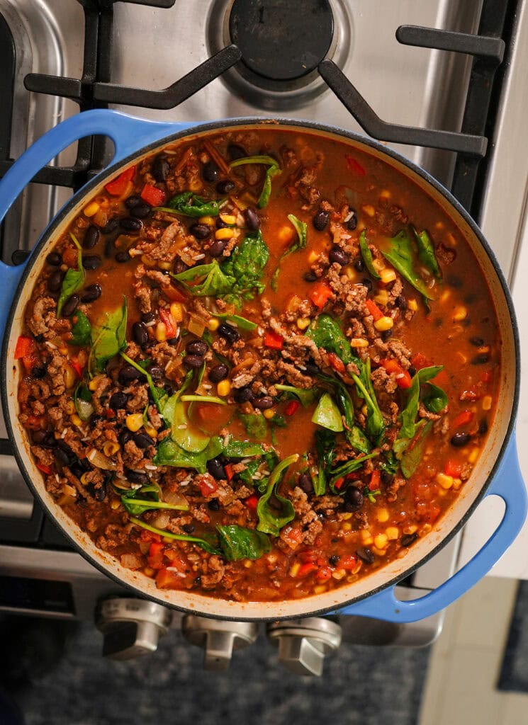 The skillet Mexican beef and rice with everything mixed in before it starts to simmer. 