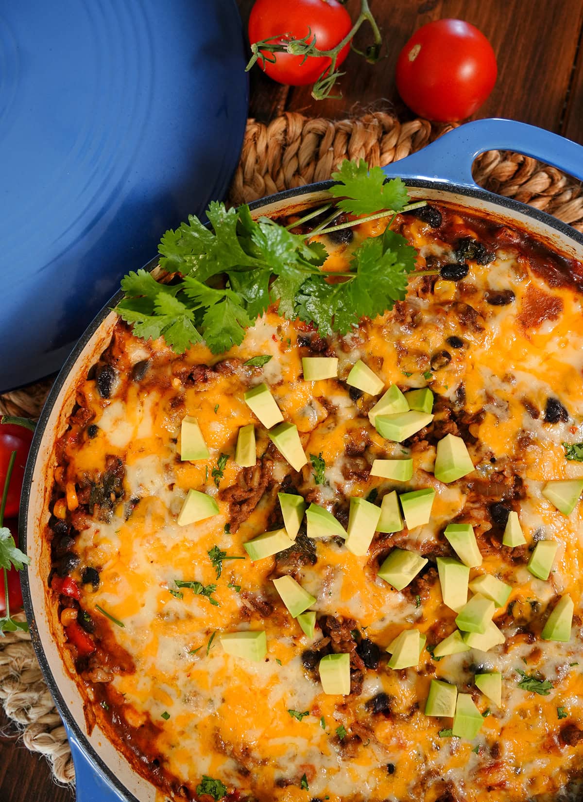 A top view of Skillet Mexican beef and rice showing diced avocados and cilantro. 