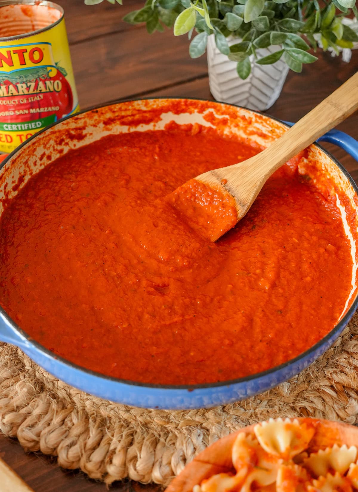 A pan of San Marzano Tomato sauce with a wooden spoon. 