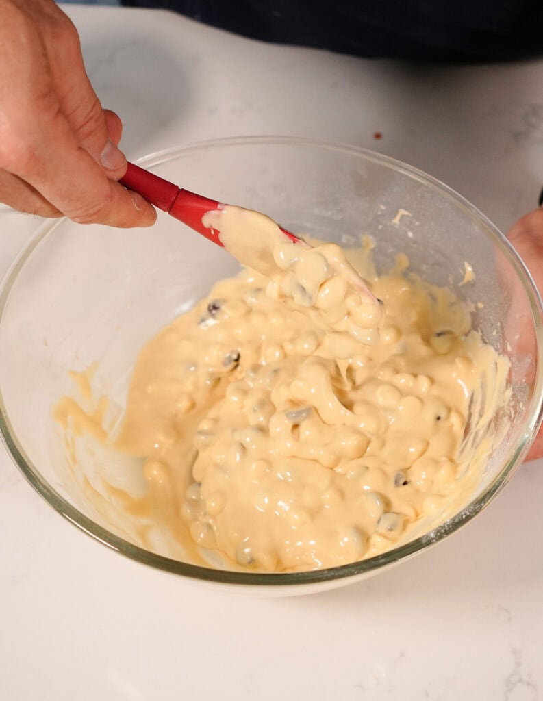 A bowl of white chocolate brownie batter mixed up.  