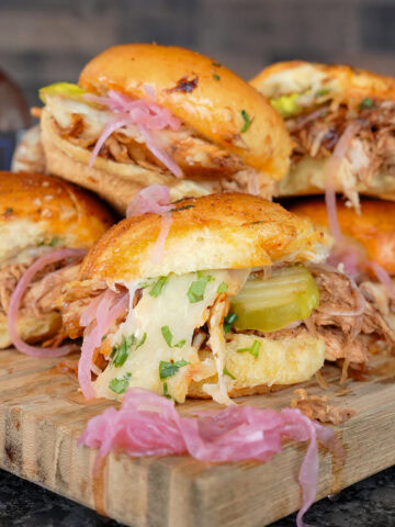 bbq chicken sliders with pickled red onions.