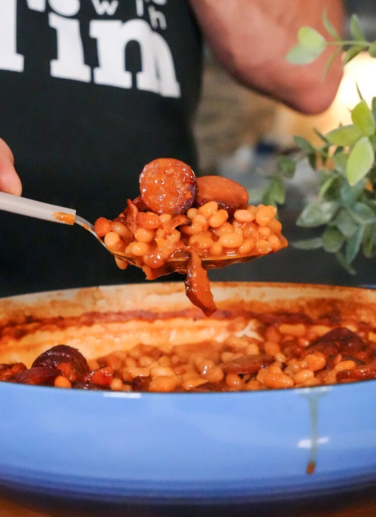 a scoop of cooked baked beans and sausage.