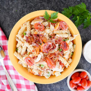 pasta salad with chicken, bacon, ranch and peppers topped with parsley.