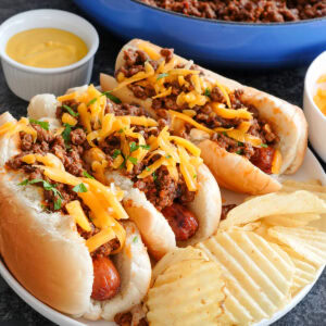 hot dogs topped with chili and cheddar cheese.