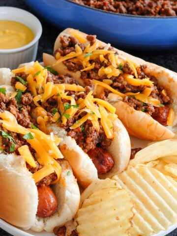hot dogs topped with chili and cheddar cheese.