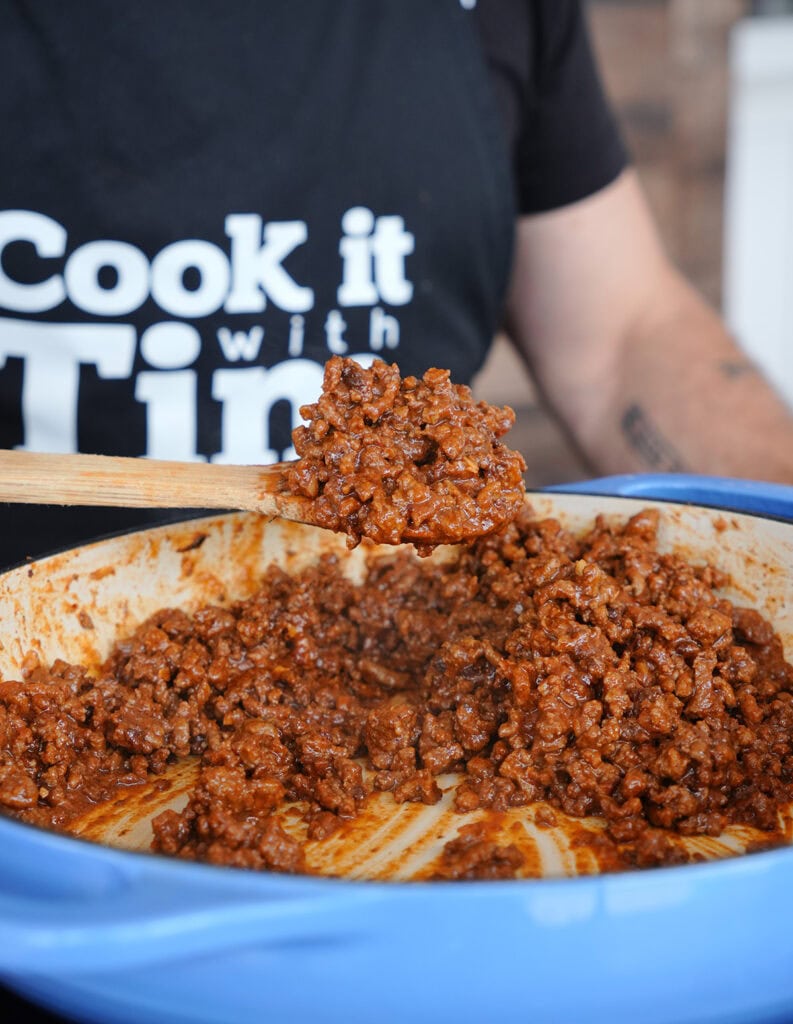 A Dutch oven full of savory chili. 