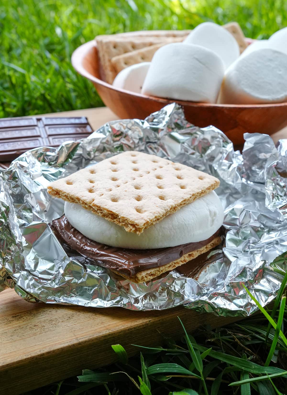 A close up of a grilled s'more showing melted chocolate and marshmallows.