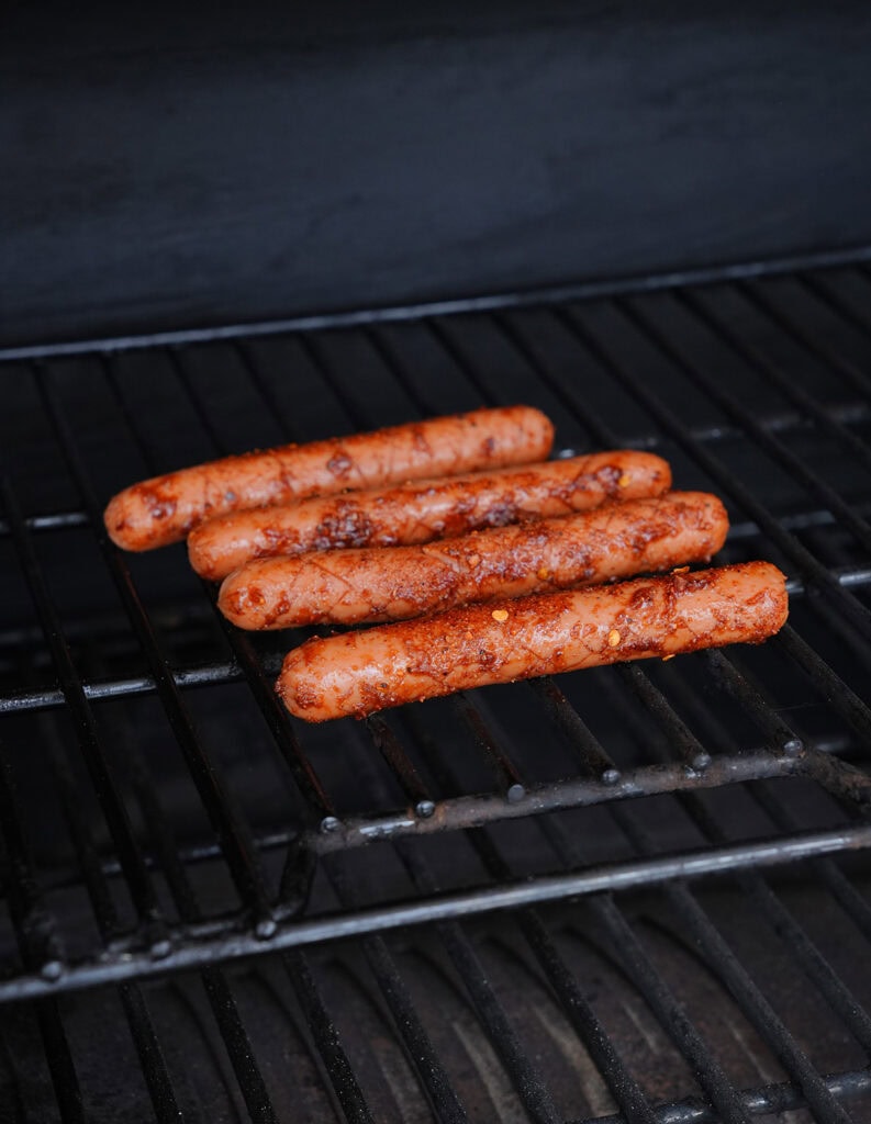Hot dogs smoking on a pellet smoker.