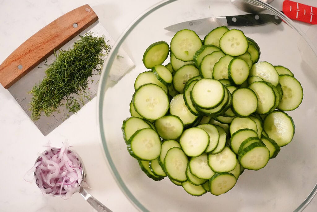 cucumber cut into half moons and chopped dill and onion.
