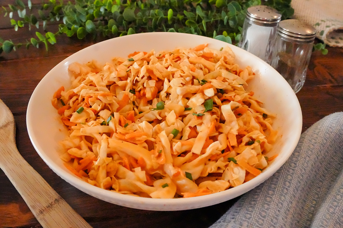 Coleslaw with bbq sauce and shredded cabbage and carrots.