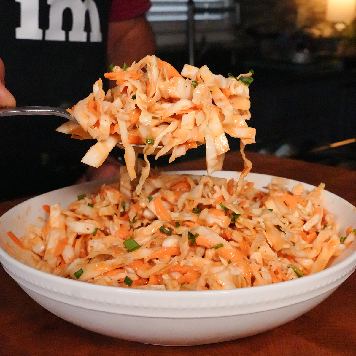 a spoonful of coleslaw with bbq sauce.