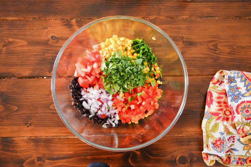 ingredients for salsa in a mixing bowl.