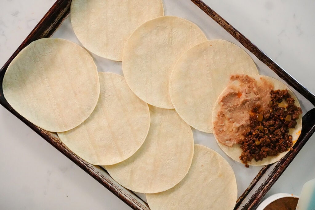 corn tortillas with beans and ground beef.