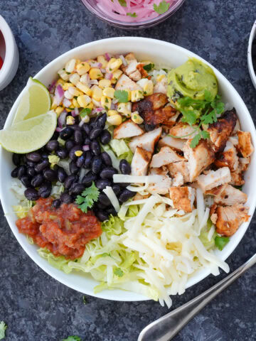 Chipotle burrito bowl with chicken, beans and toppings.