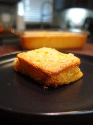 a slice of corn casserole on a plate.