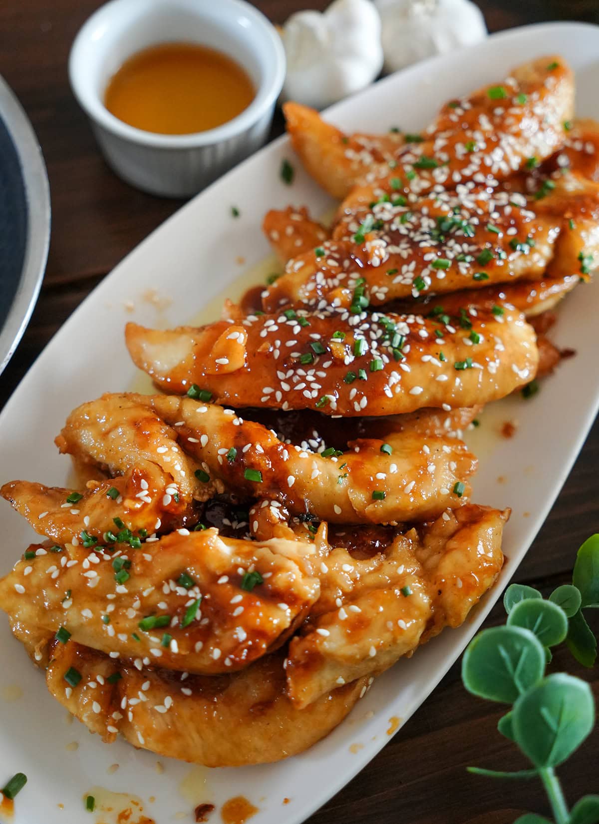 chicken fingers coated in honey garlic glaze topped with sesame seeds.