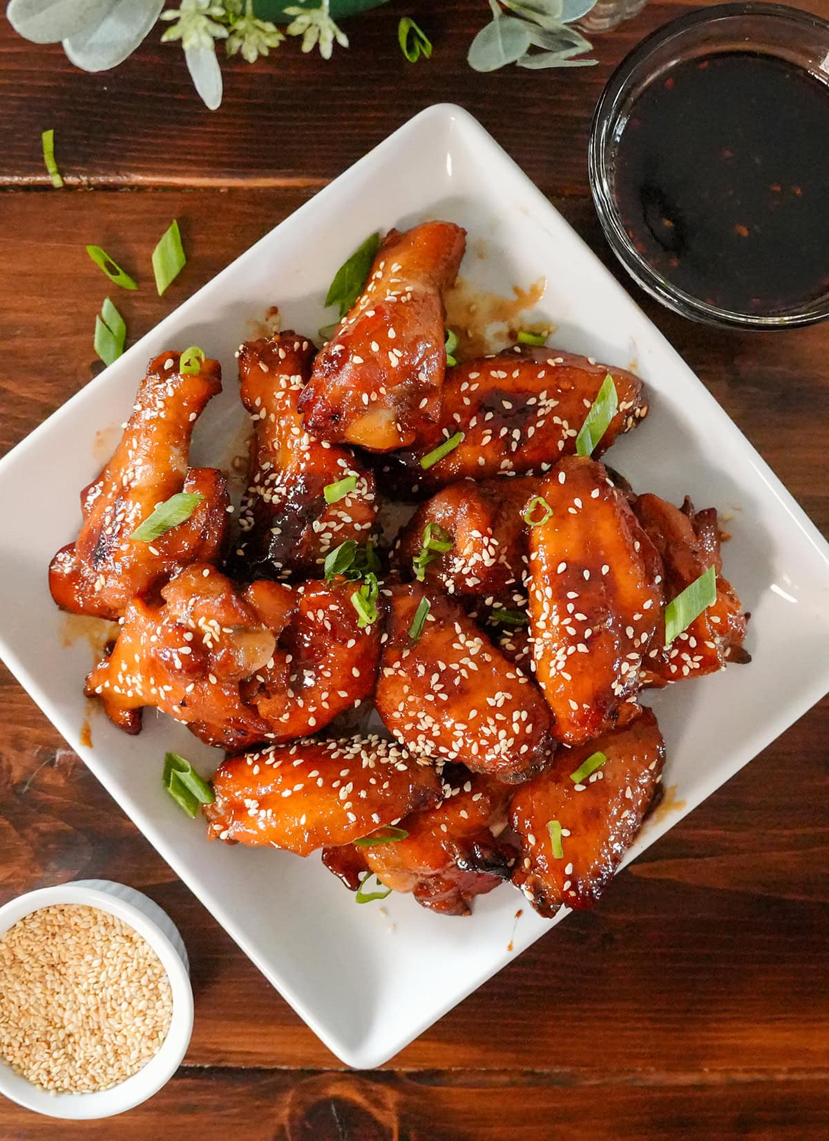baked teriyaki chicken wings with sesame seeds and chives.