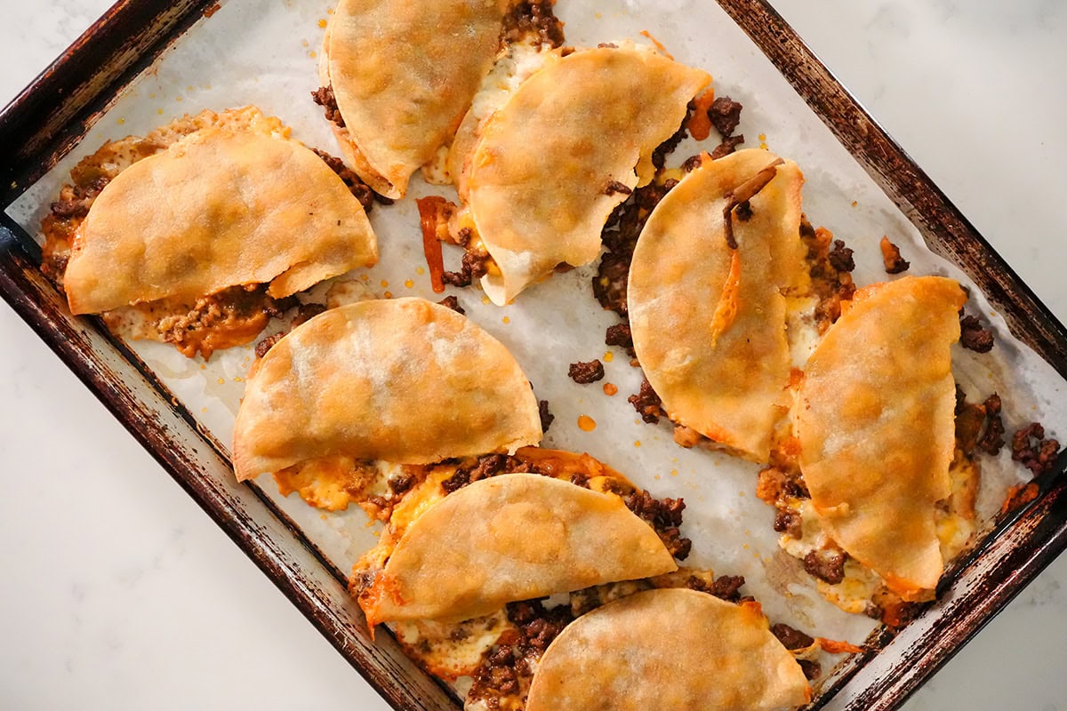 baked tacos on a baking sheet fresh out of the oven.