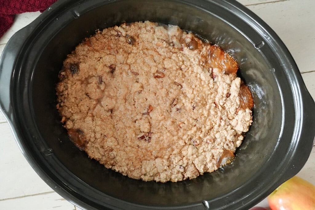 apple dump cake in a slow cooker with a crumble crust.