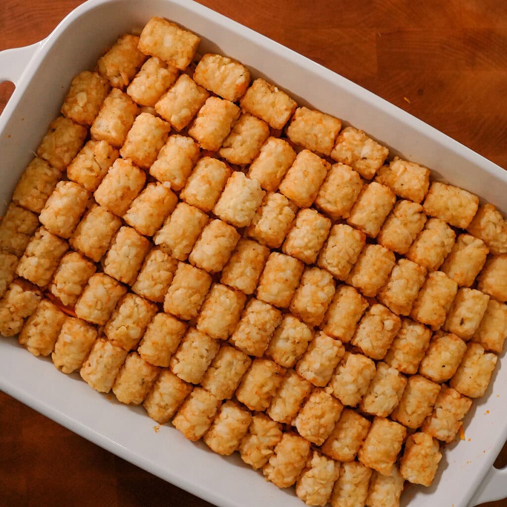 tater tots lined up on a taco casserole.