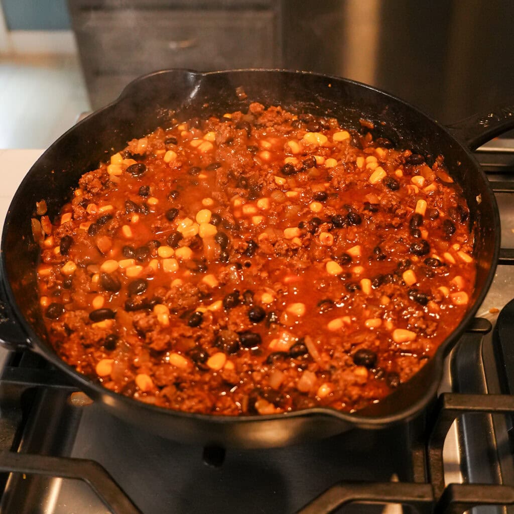taco tater tot casserole filling in a skillet.