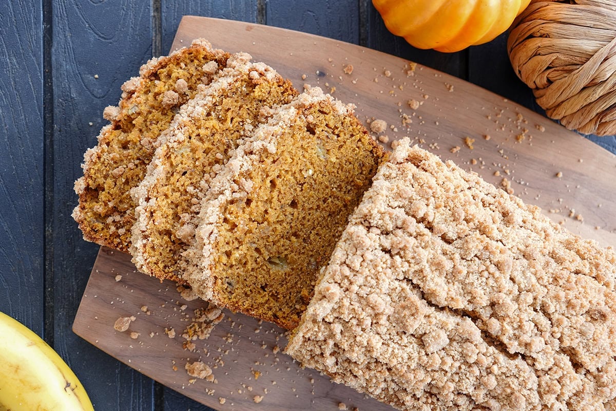 sliced of banana pumpkin bread on a cutting board.