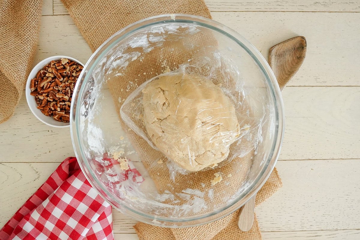 a ball of cookie dough wrapped in plastic wrap.