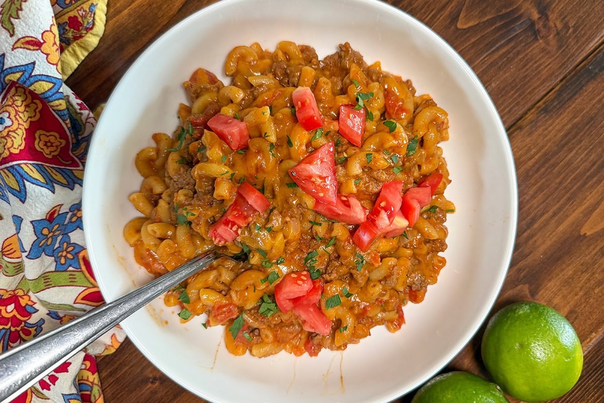 Taco Mac and Cheese topped with cilantro and tomatoes.