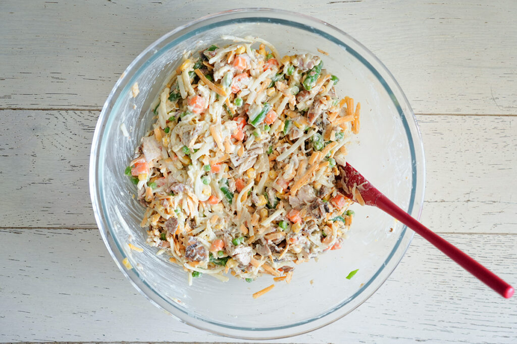 mixing bowl full of chicken and hashbrown mixture.