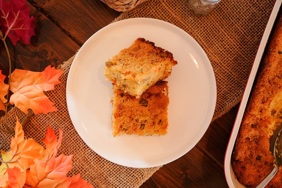 squares of cornbread on a plate by fall decor.