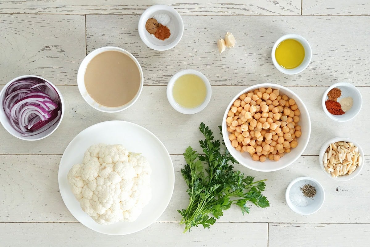 Ingredients for building a roasted cauliflower salad with dressing.