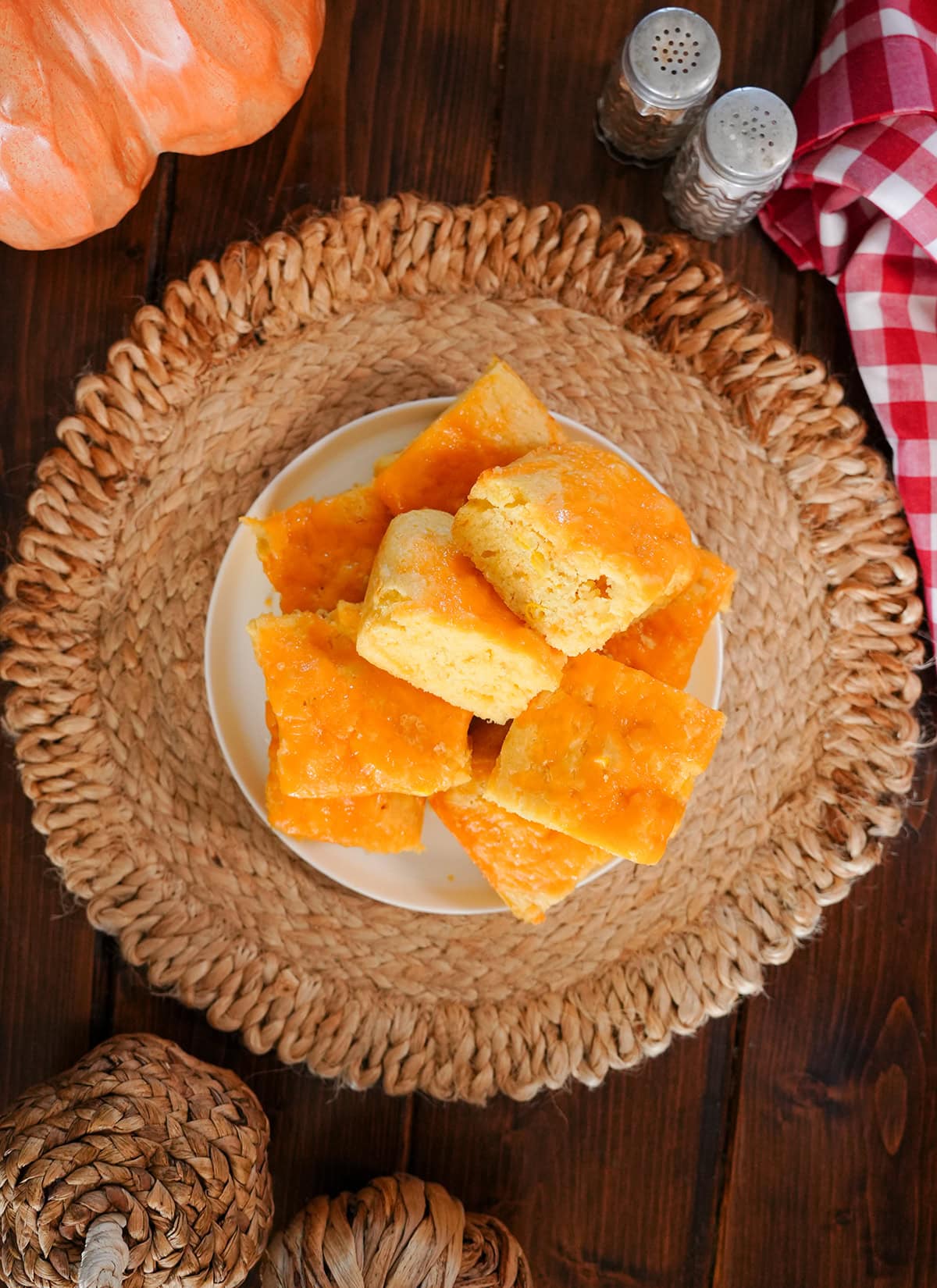 slices of cheesy cornbread on a plate with holiday decor.