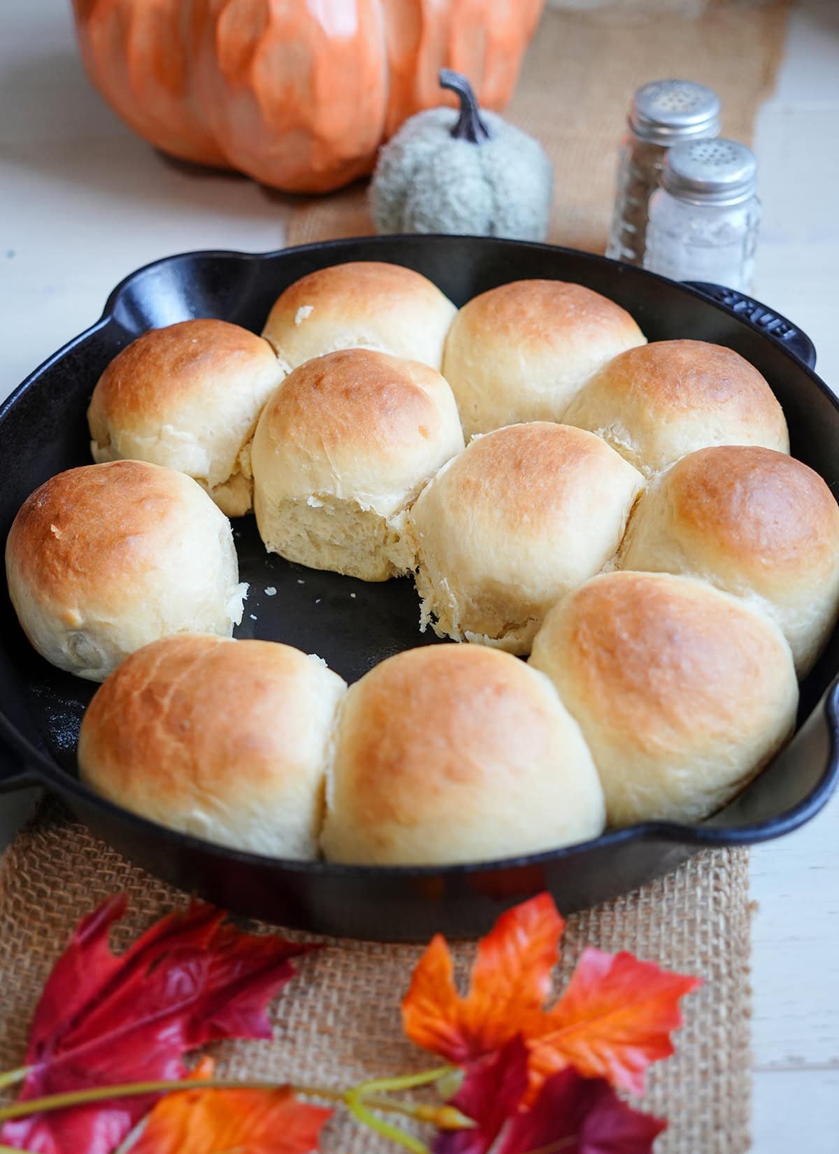 Golden yeast rolls in a cast iron skillet by decor.