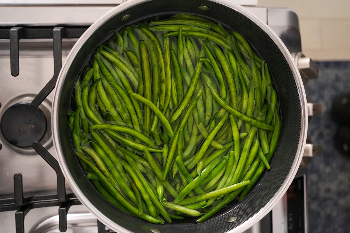 Green beans blanching in a stock pot.