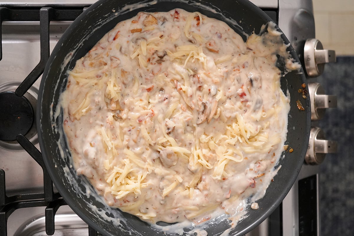a cream sauce with cheese in a skillet.