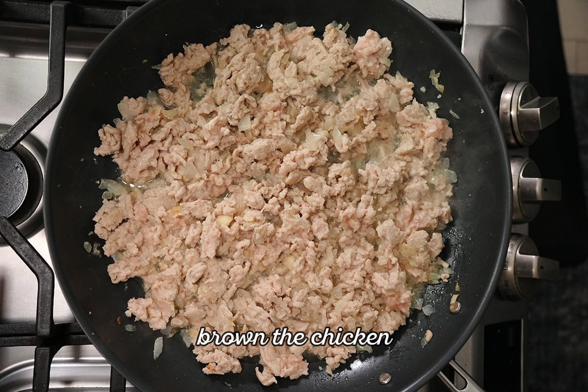 chicken browning in a skillet.