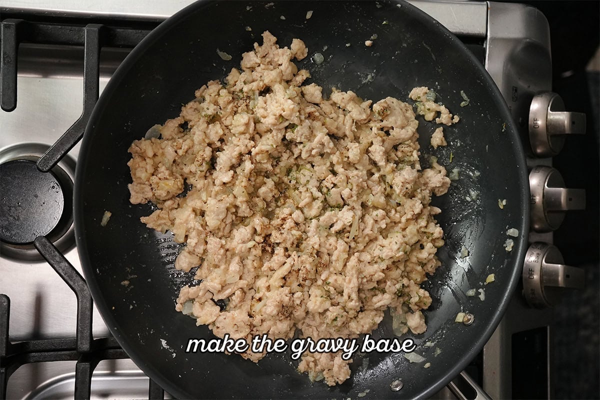 chicken and herbs cooking together in a skillet.