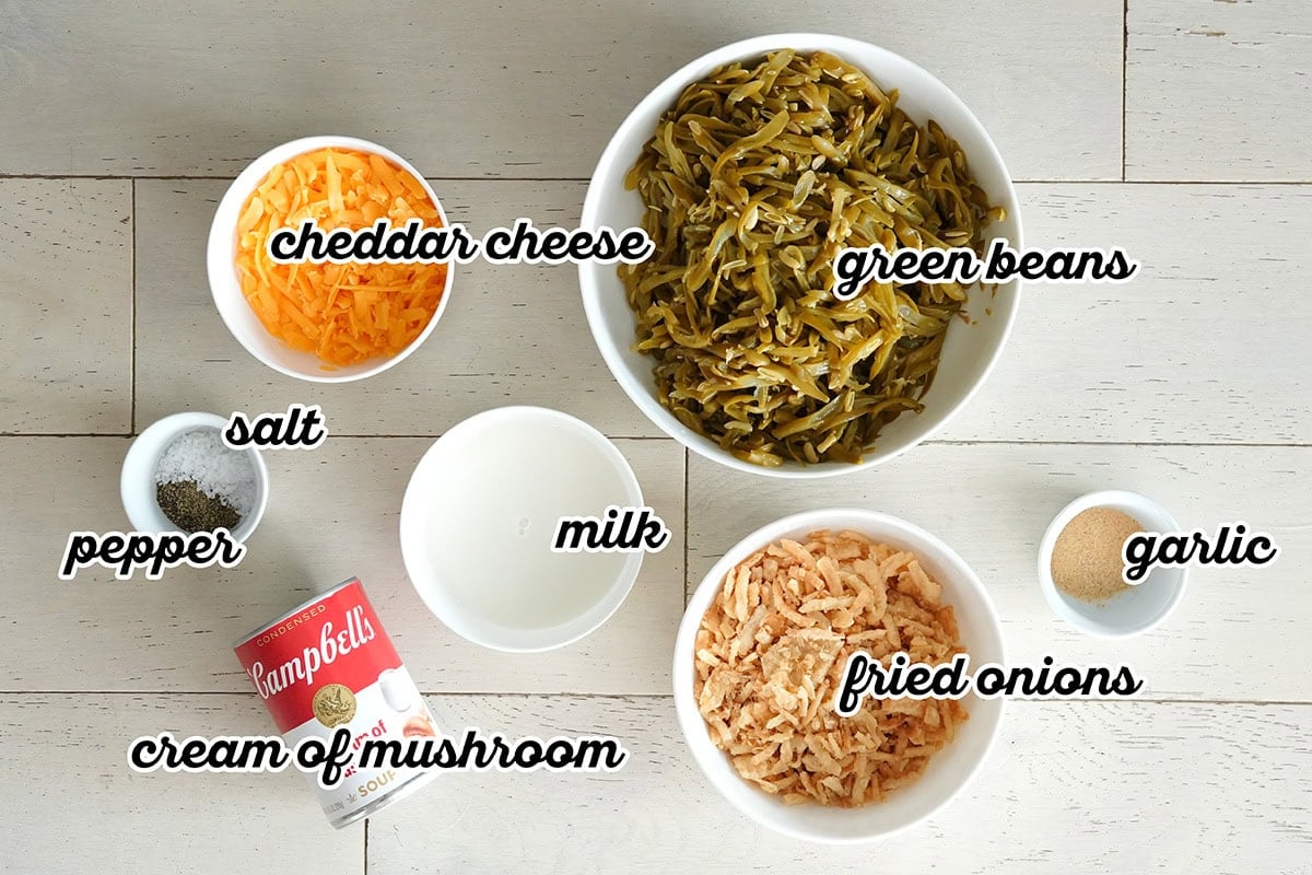 labeled ingredients for making a green bean casserole in a slow cooker.