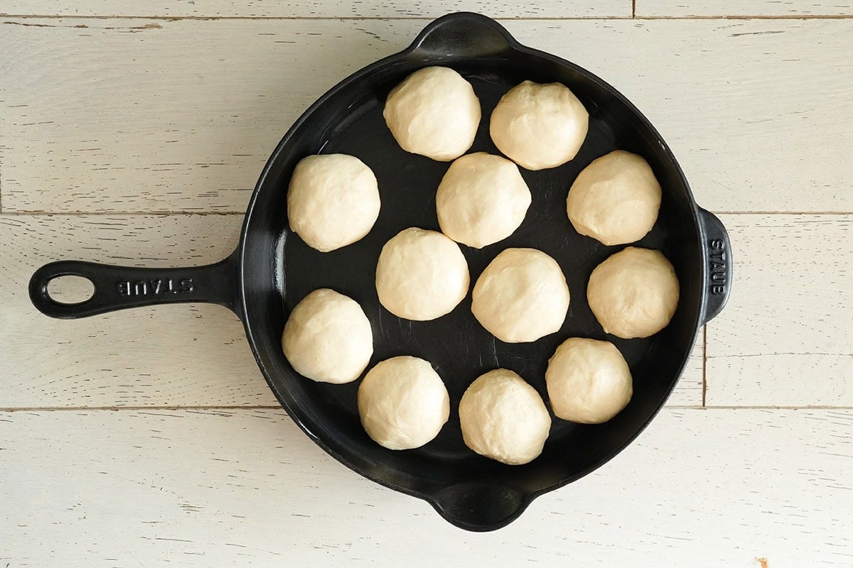 12 dough balls in a cast iron skillet.