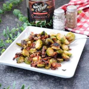 brussels sprouts with bacon and maple syrup on a plate.