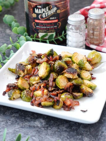 brussels sprouts with bacon and maple syrup on a plate.