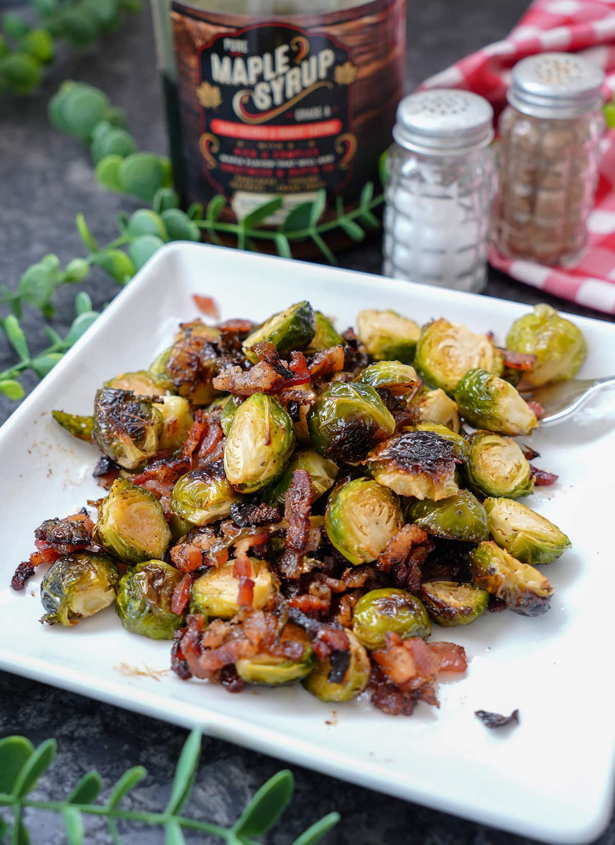 Brussels Sprouts with bacon and maple syrup on a plate.