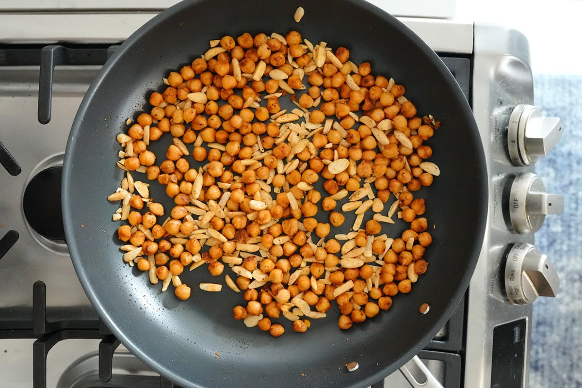 golden chickpeas and almonds in a skillet.