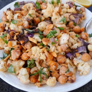 A cauliflower salad with dressing and parsley.