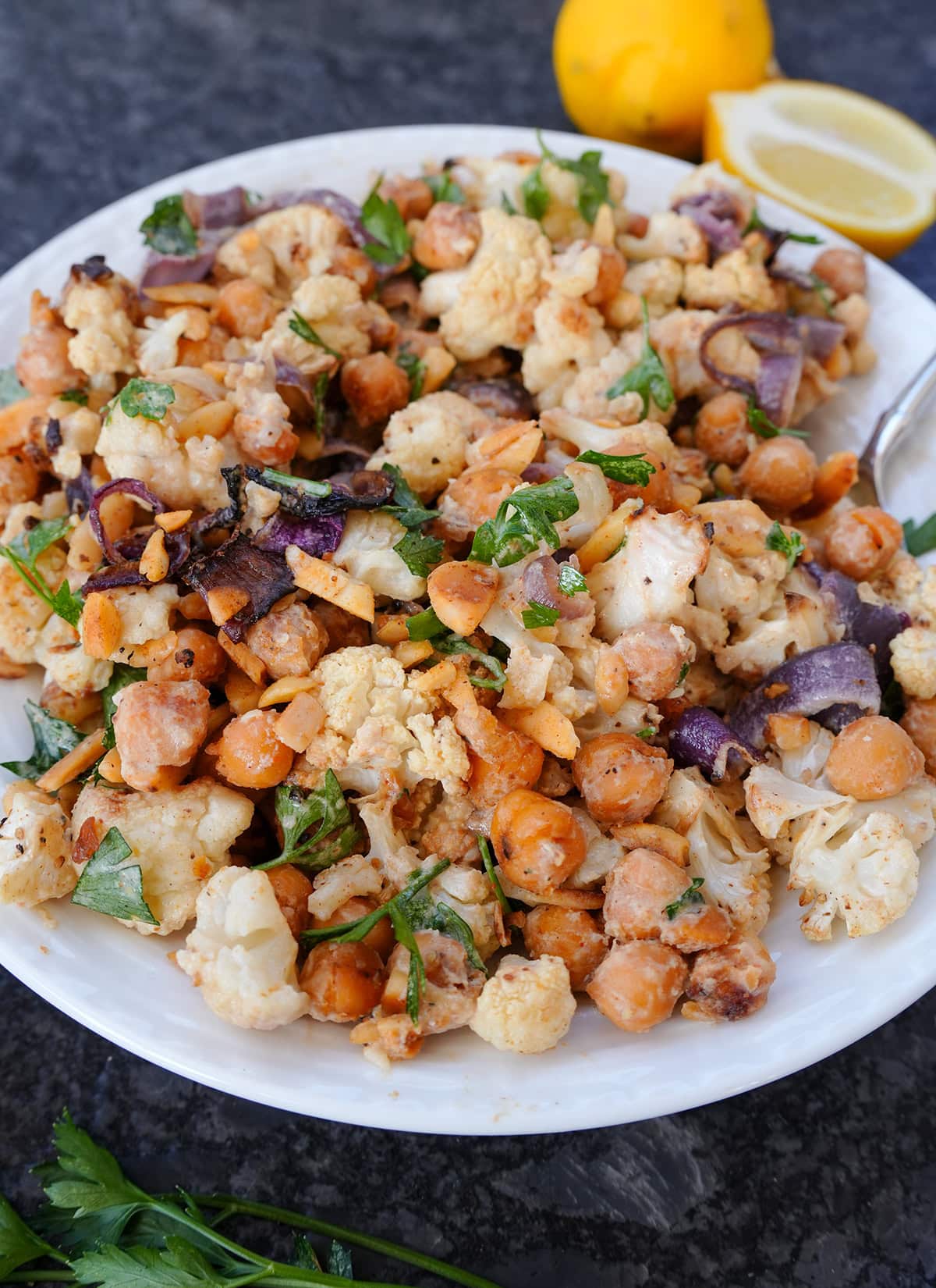 Cauliflower salad with onions, chick peas and parsley.