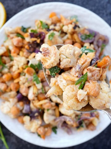 A cauliflower salad with parsley and onions.