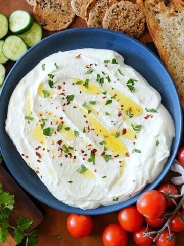 whipped feta dip served with tomatoes and cucumbers.